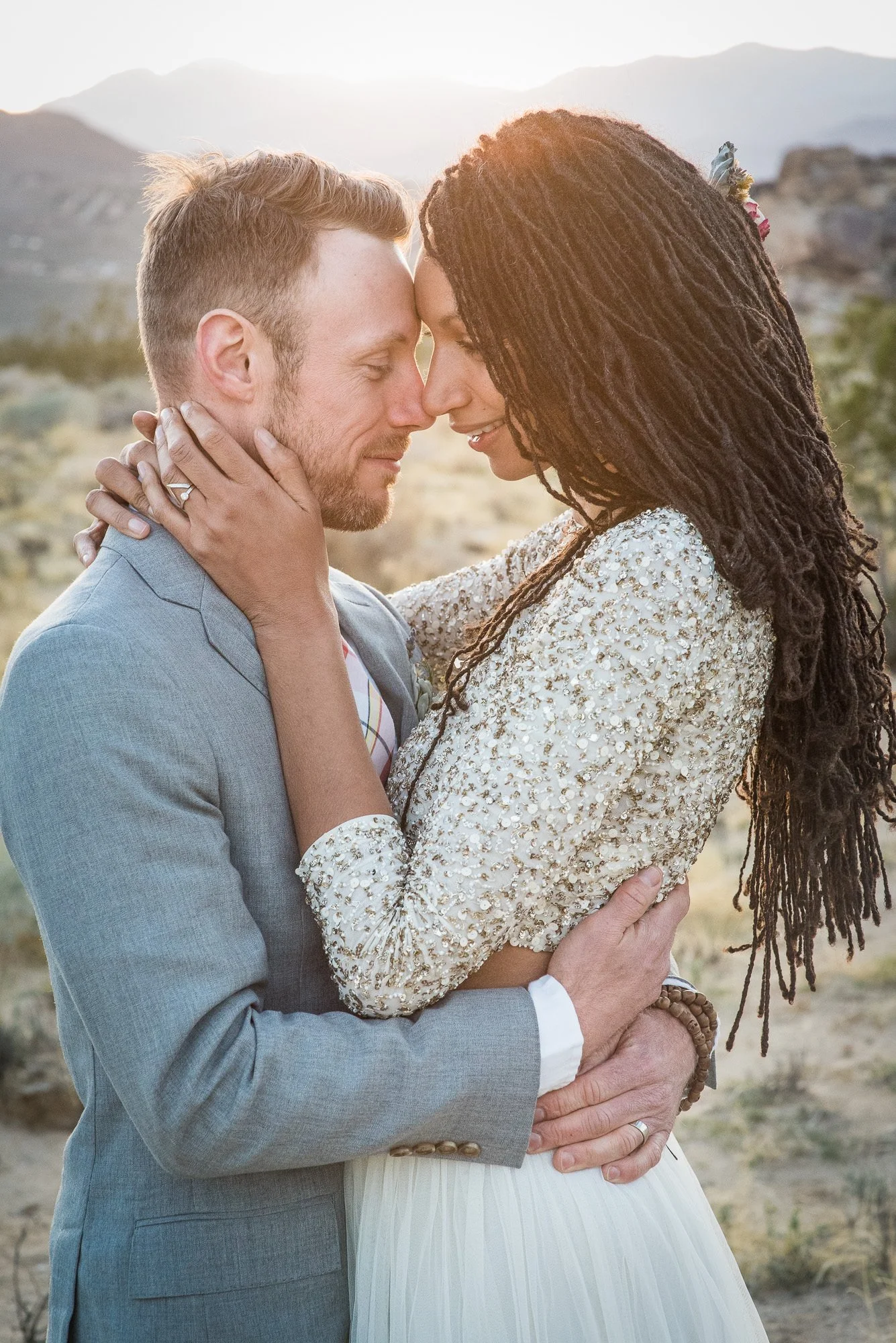 Bride and groom embrace in quiet moment after exchanging vows in Joshua Tree