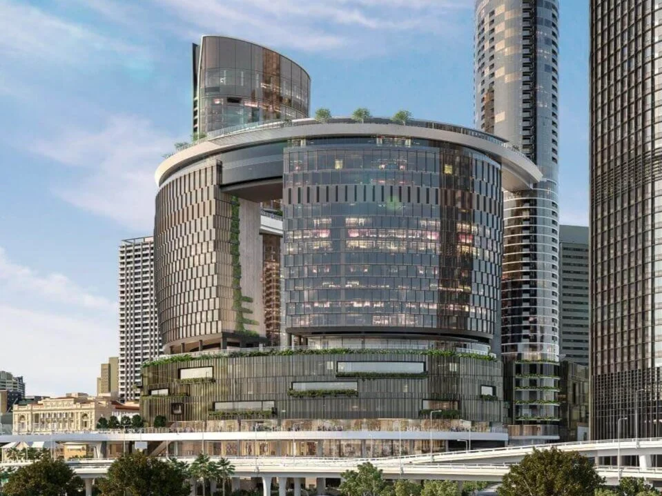 Modern high-rise buildings in an urban cityscape with glass facades and levels with greenery.