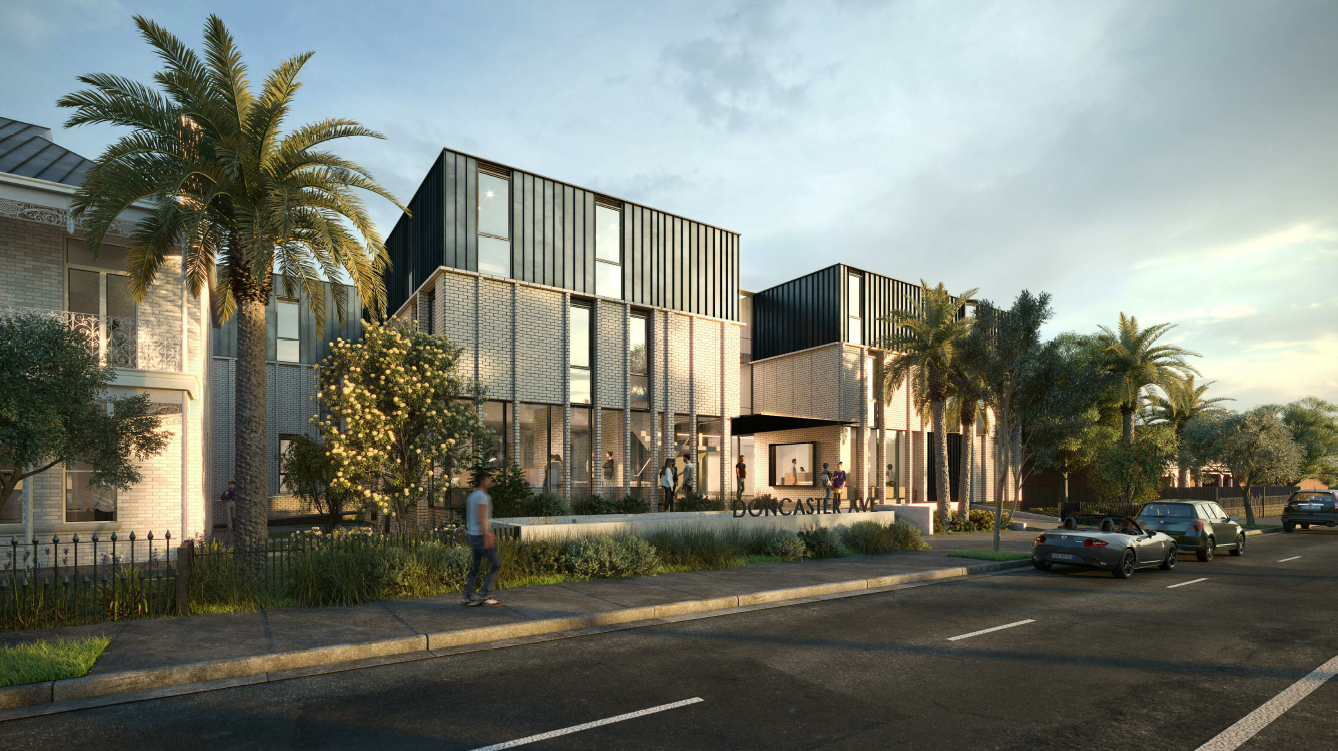 Modern multi-story building with glass and metal panels, surrounded by palm trees and landscaped greenery, with people walking on the sidewalk and cars parked in front.