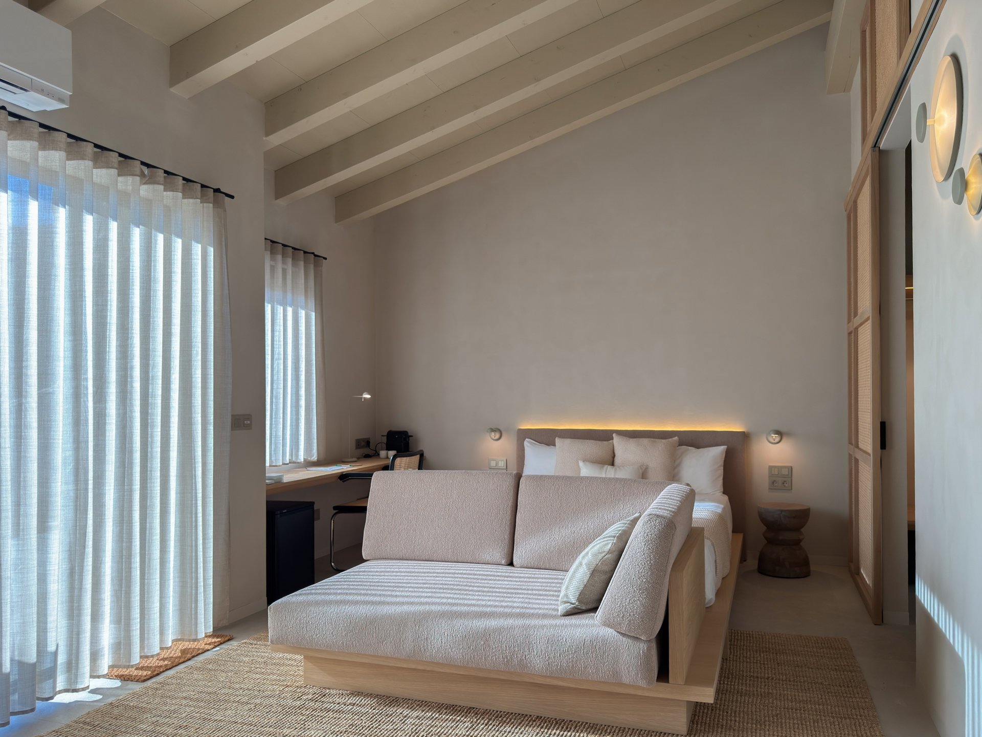 Suite with mountain view at Seven By Bussacs, luxury boutique hotel in the Spanish Pyrenees, bed with sofa