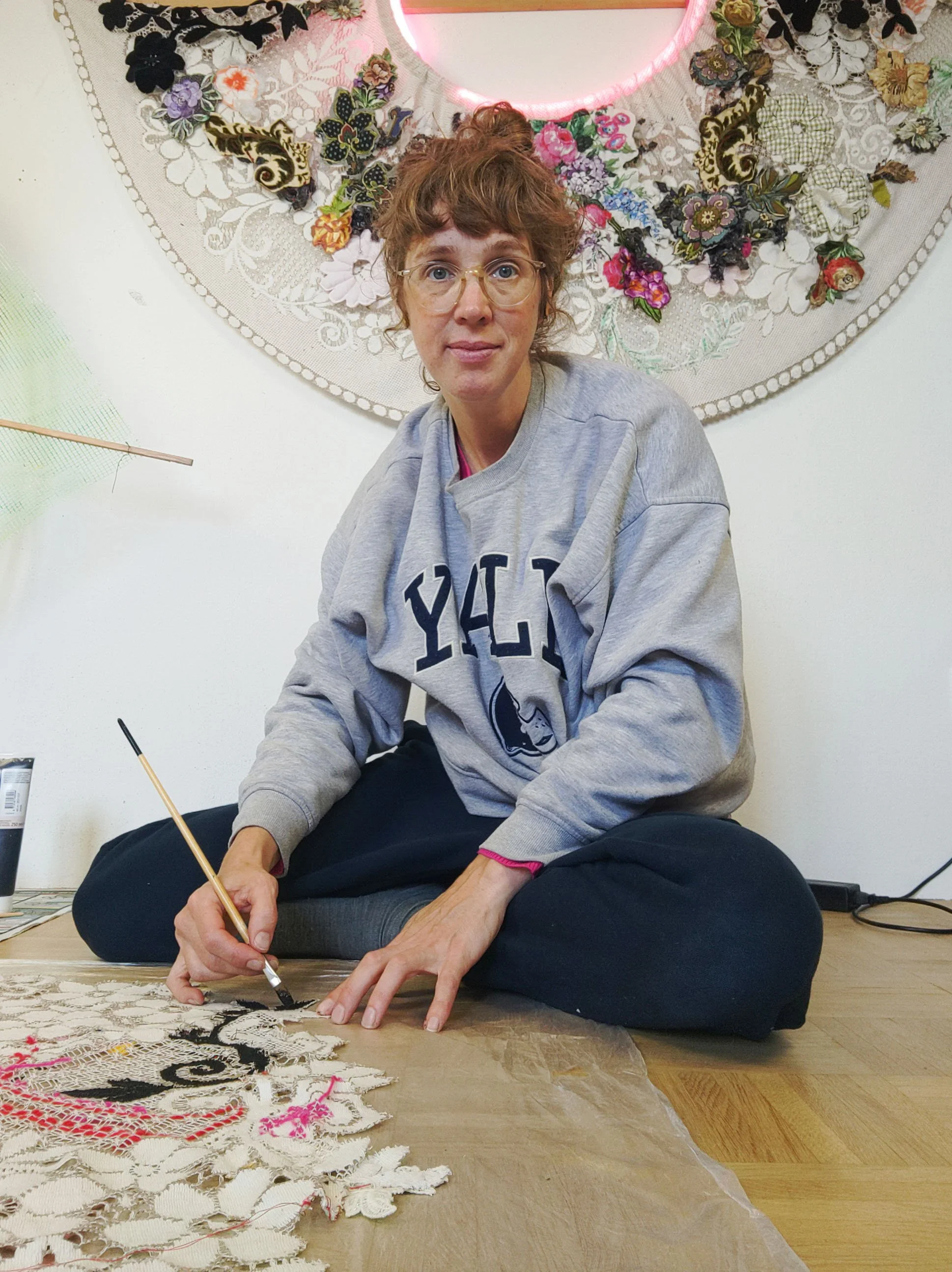 Artist at work in studio painting textiles