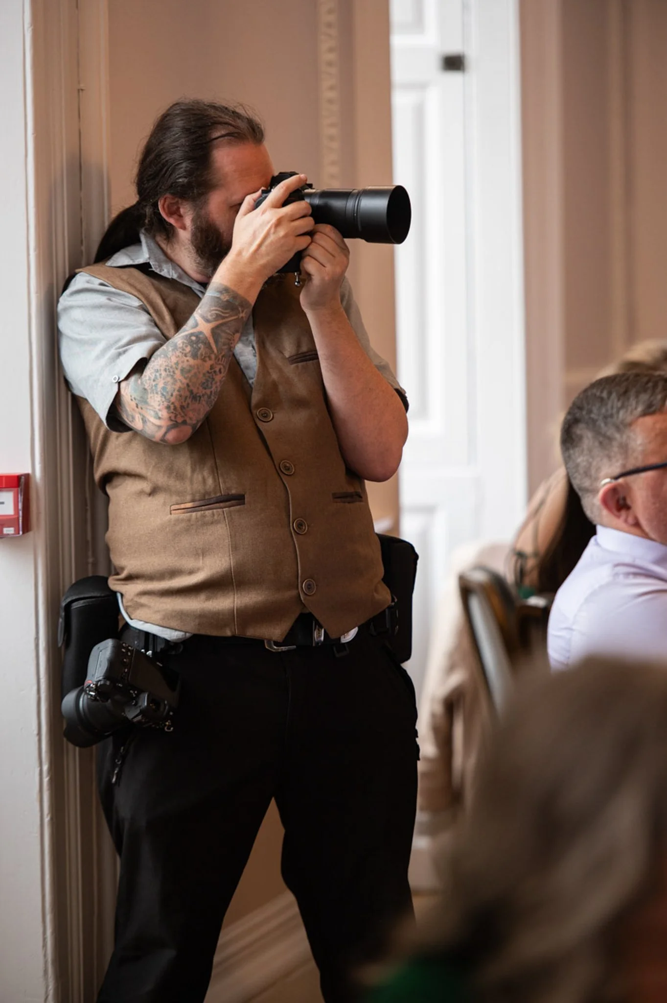 Ian Petrie's photography - Ian Petrie, Photographer holding a nikon camera up to photograph a wedding in Nottingham