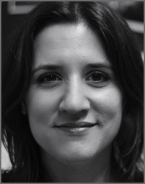 Close-up black and white photo of a woman with shoulder-length dark hair, smiling softly.