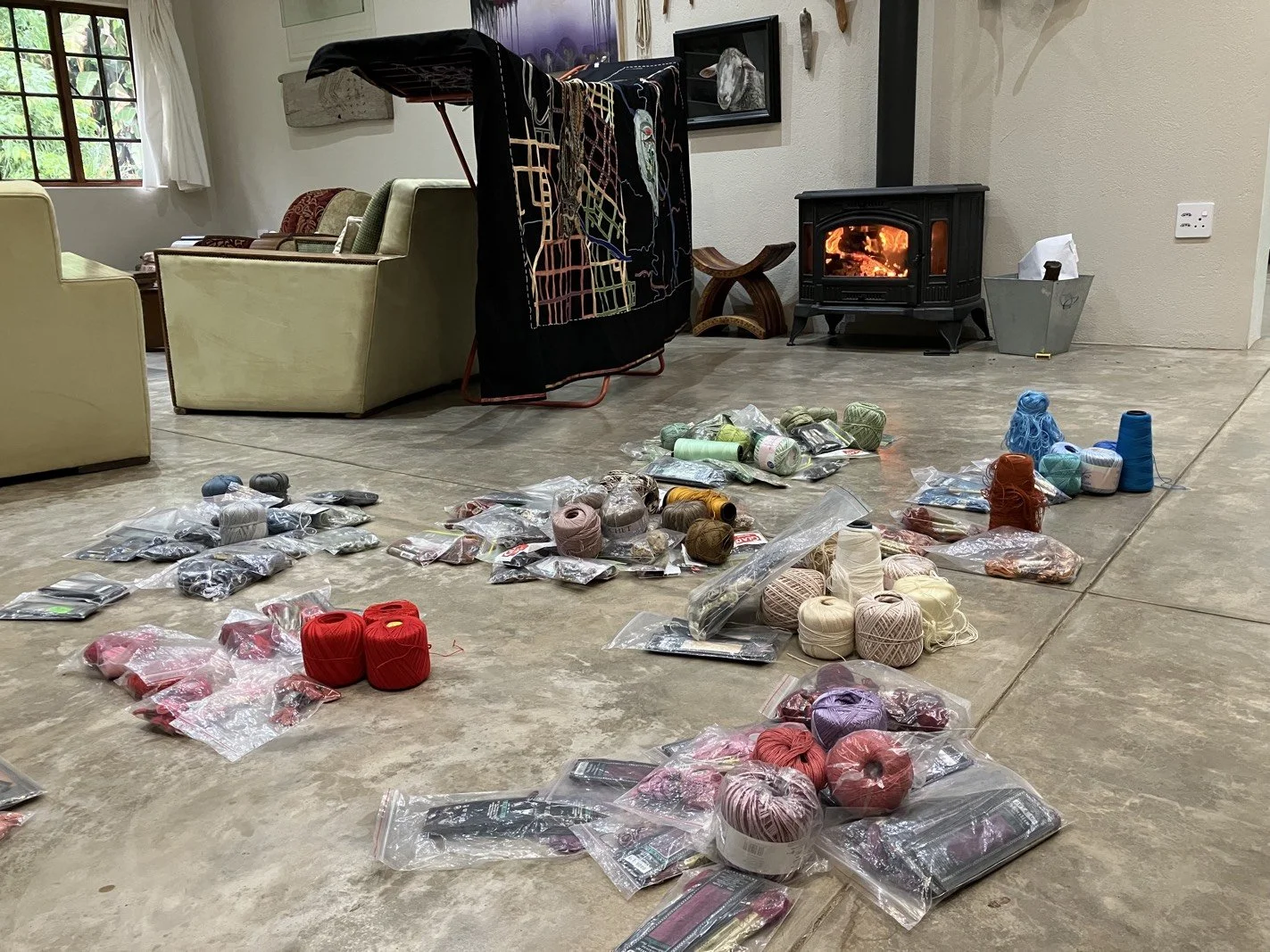 Sorting thread while embroidery dries in front of a fire