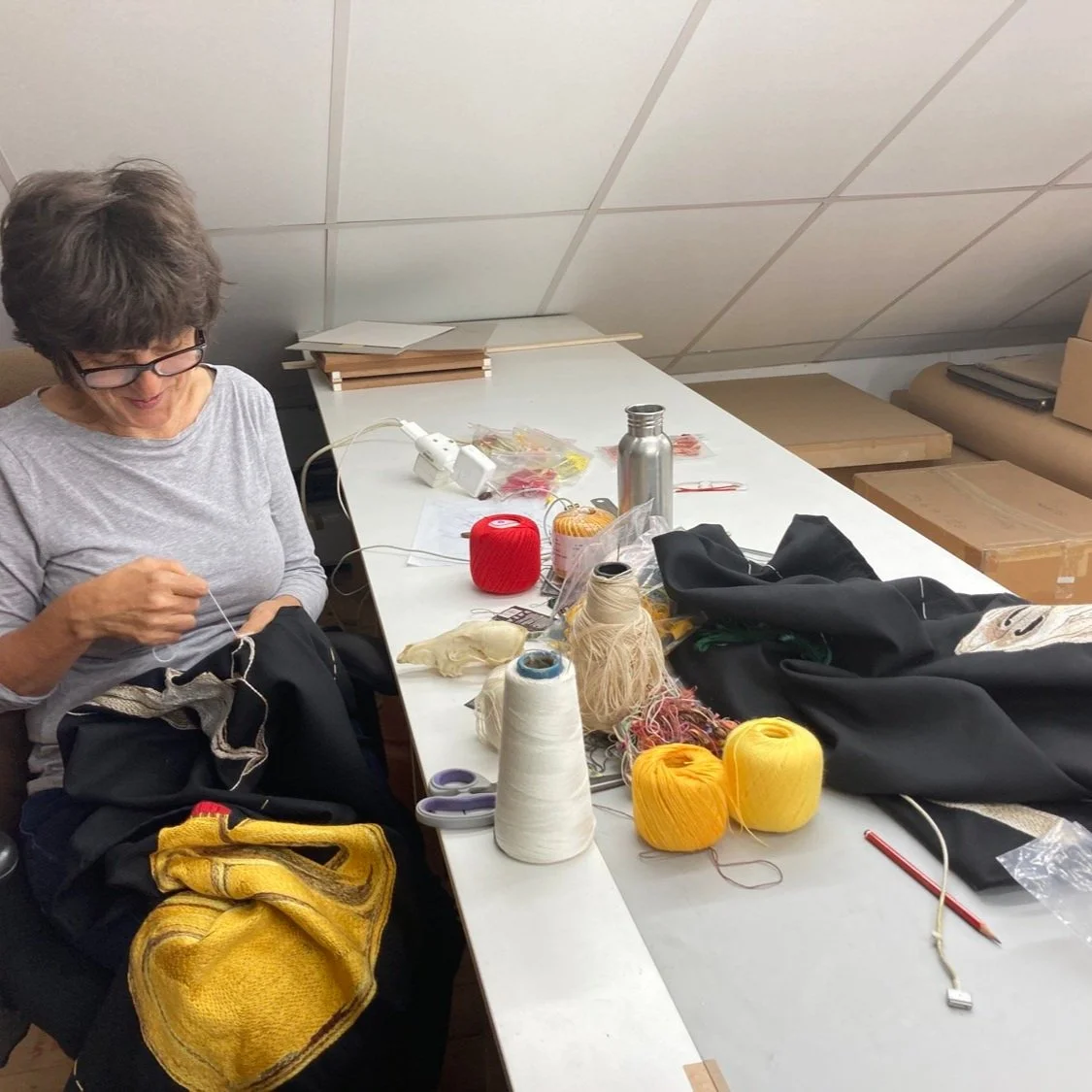Tamar Mason working on embroidery