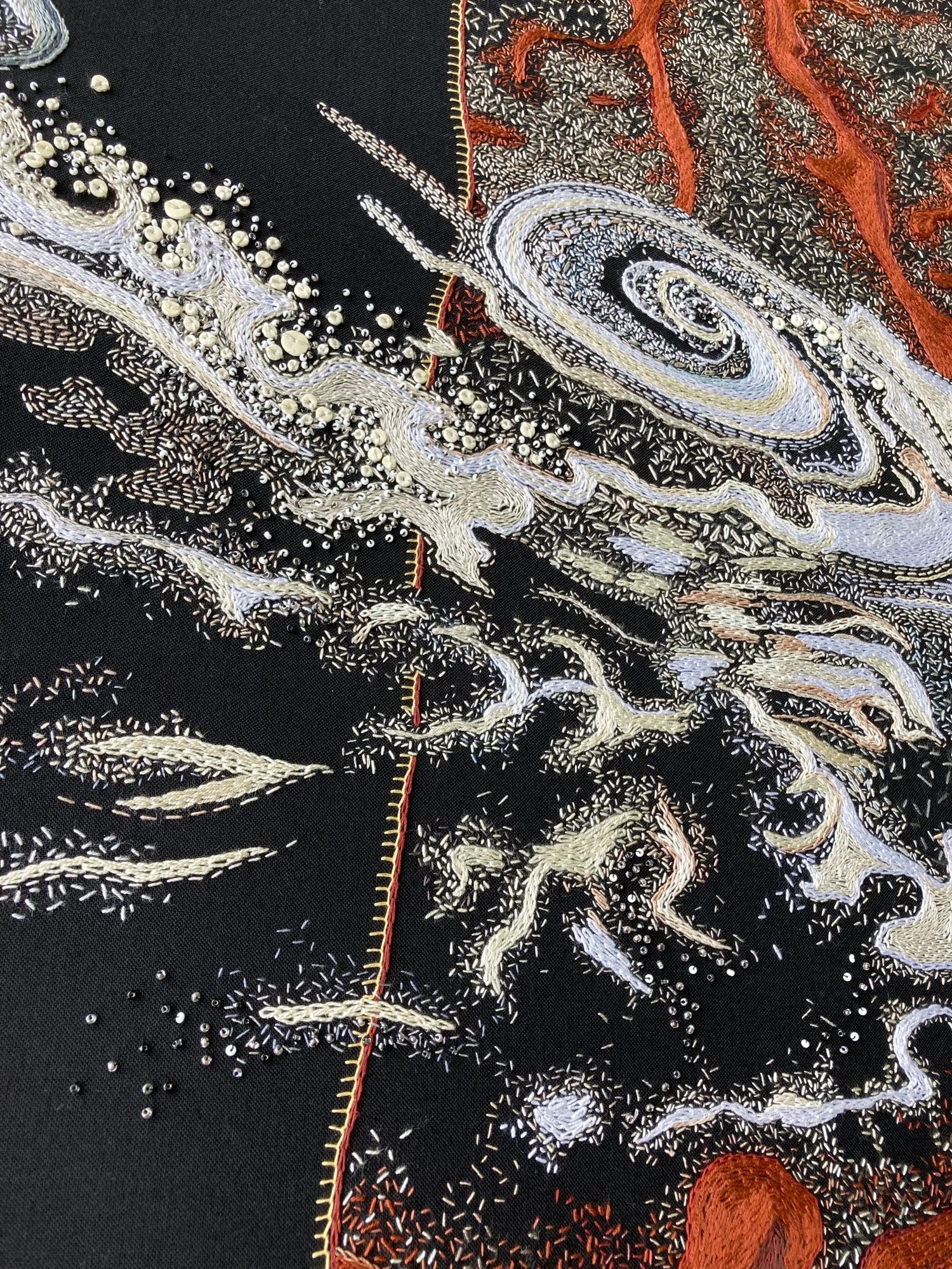 Deatil of cyclone embroidered by Tamar Mason with beadwork