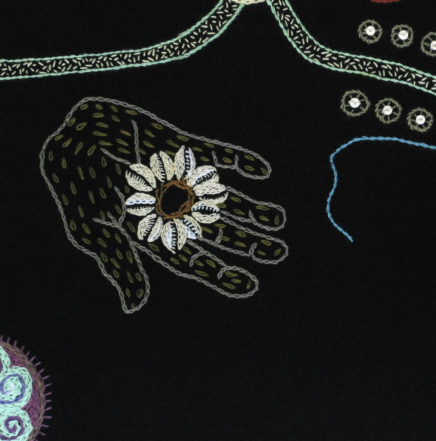 Hand and cowrie detail of portrait by Tamar Mason