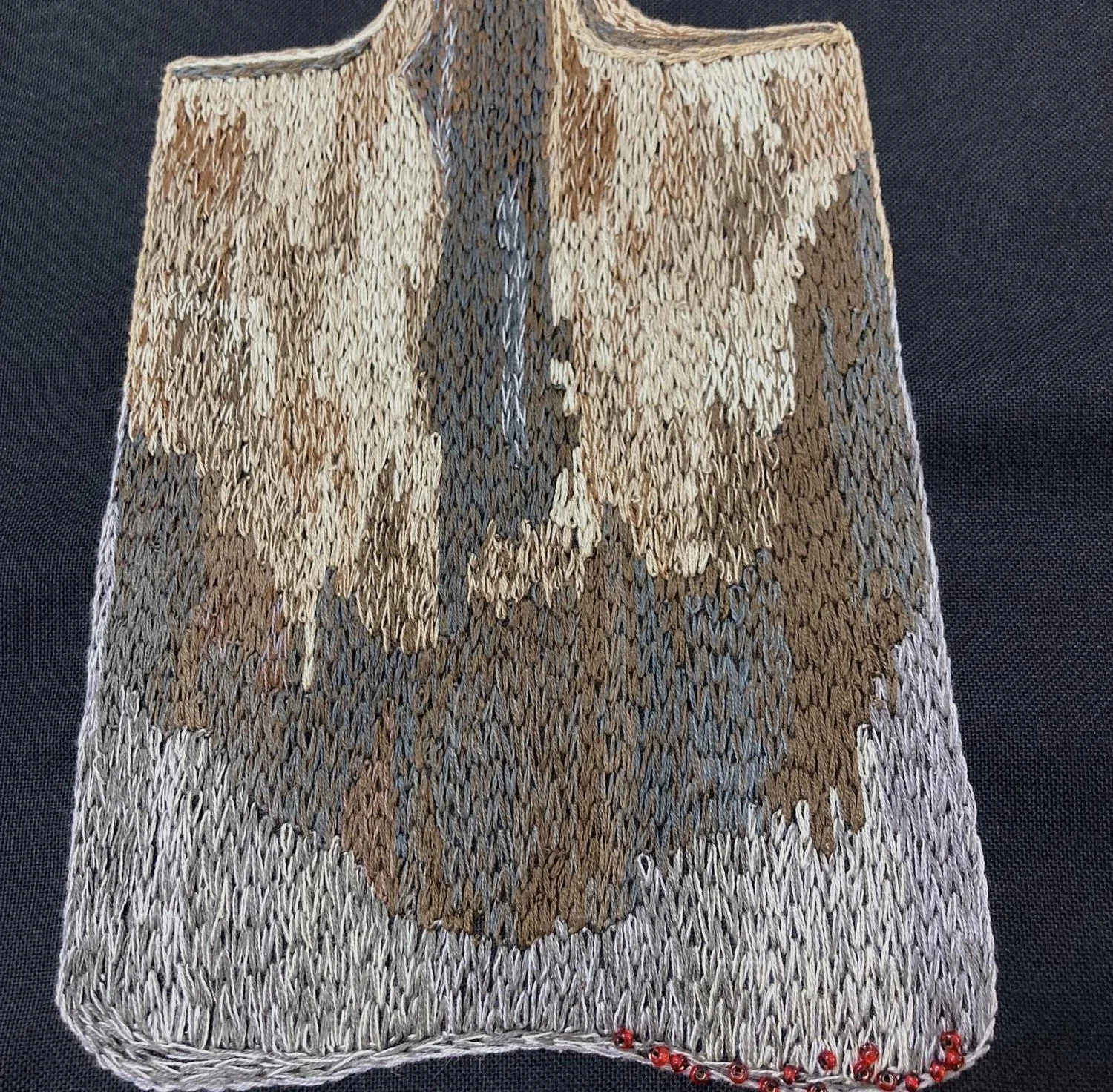 Detail of spade with blood red glass beads on edge by Tamar Mason