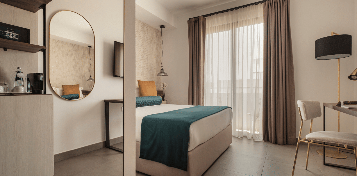 DELUXE ROOM - A refined room set on the higher floors, offering a private balcony and a serene atmosphere with elevated views.