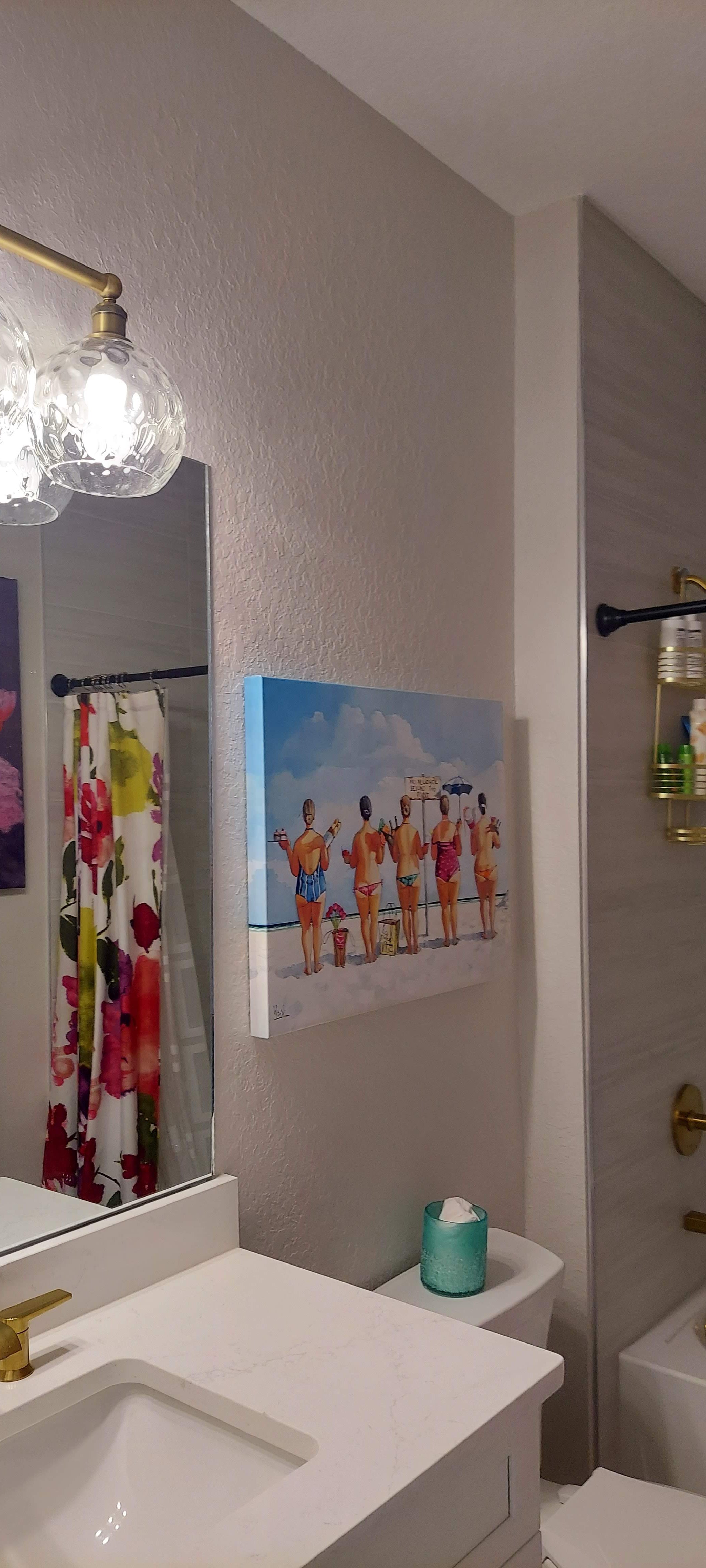 Even the guest's bathroom appears to be lighter and bigger with the light grey walls color, in this Venice Fl home.
