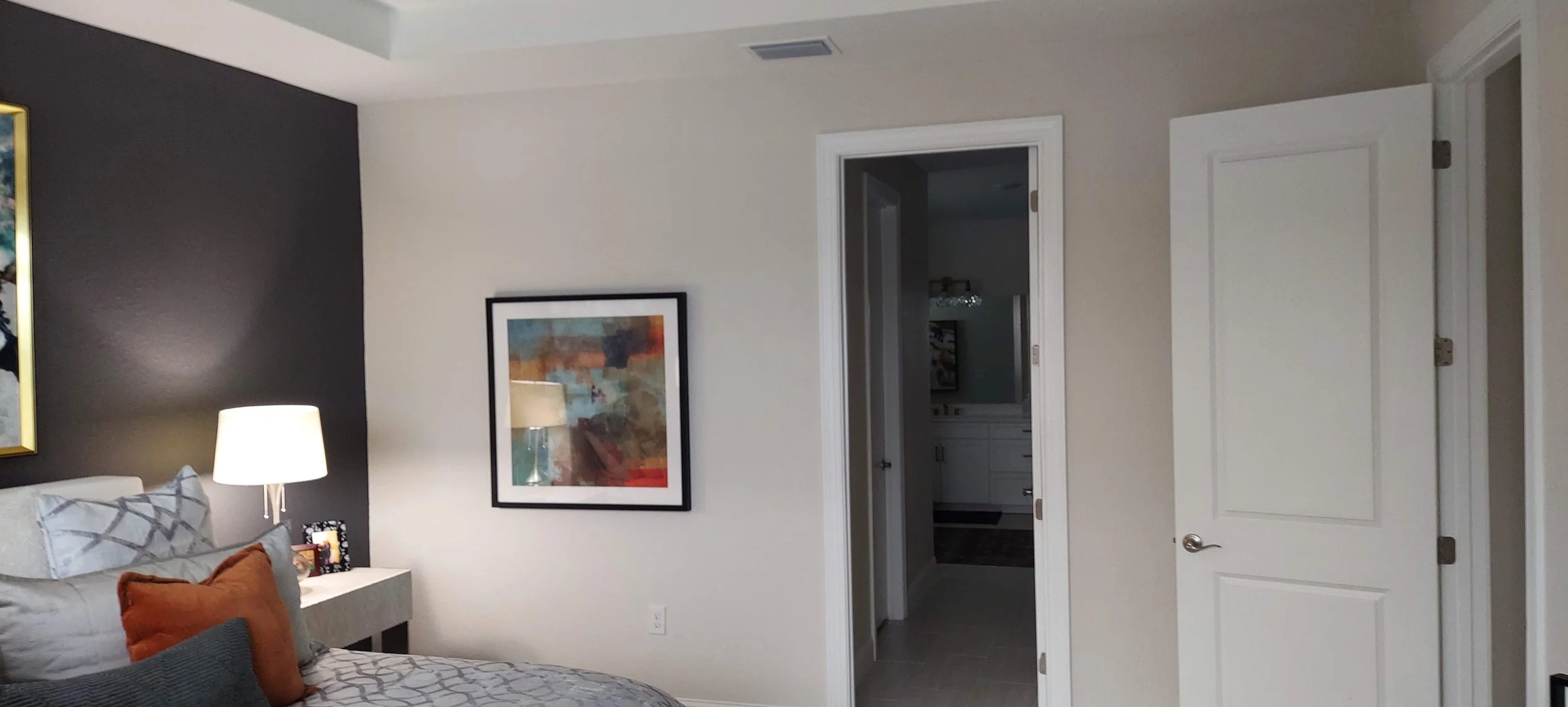 A different angle on the Master bedroom' accent dark color paint next to the light grey in this home in Venice, FL