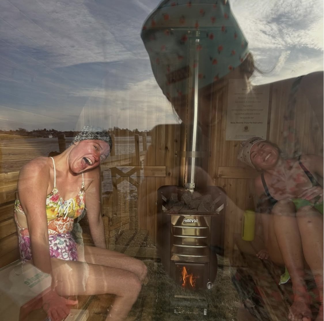 Group of women in bathing suits enjoying a beachside sauna in Narragansett