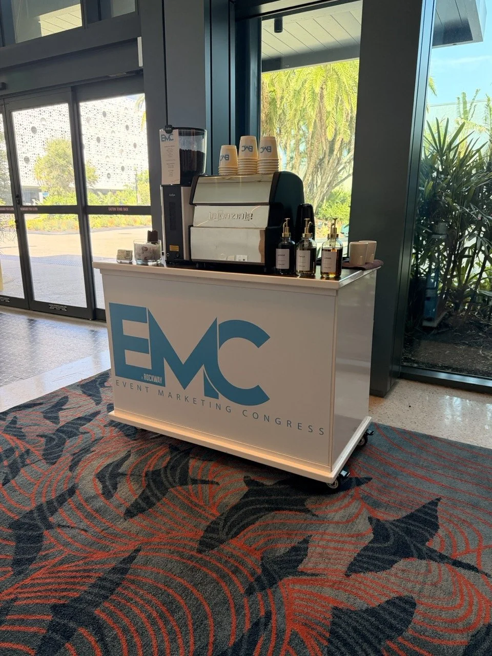 Professional mobile espresso bar by À La Mode Coffee creating a premium coffee experience at a corporate event. Our branded coffee carts, latte art printing, and handcrafted espresso drinks help businesses elevate conferences, trade shows, weddings, 