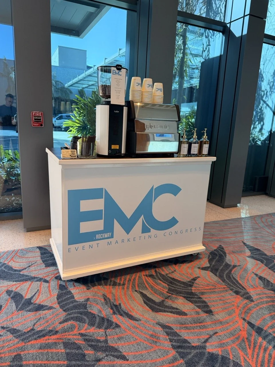 Corporate coffee bar customized with a client's logo for a successful conference. Our mobile espresso catering enhances meetings, conventions, employee appreciation events, and product launches throughout Orlando and Central Florida.