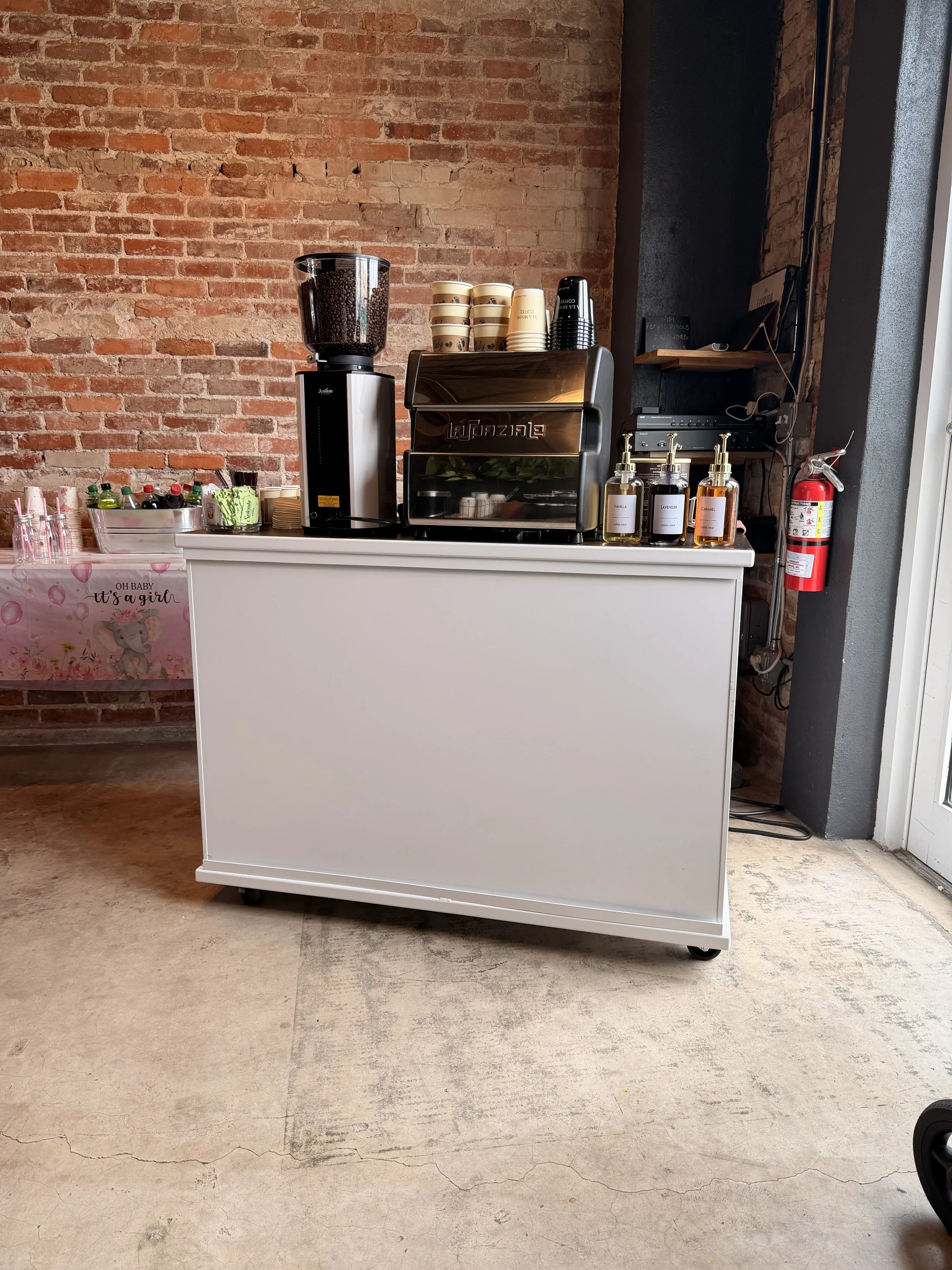 Custom branded coffee cart serving espresso drinks at a corporate event in Tampa by À La Mode Coffee