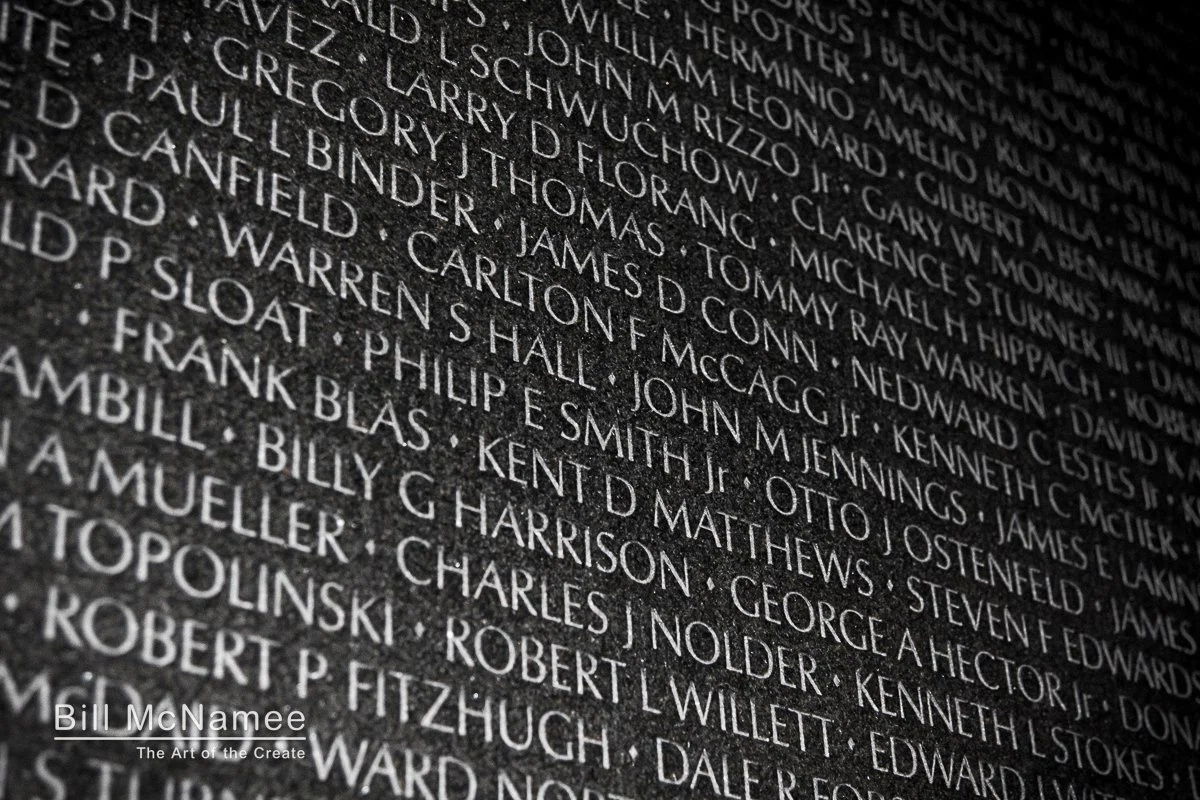 Close view of names etched into the Vietnam Veterans Memorial wall at night in Washington, D.C.