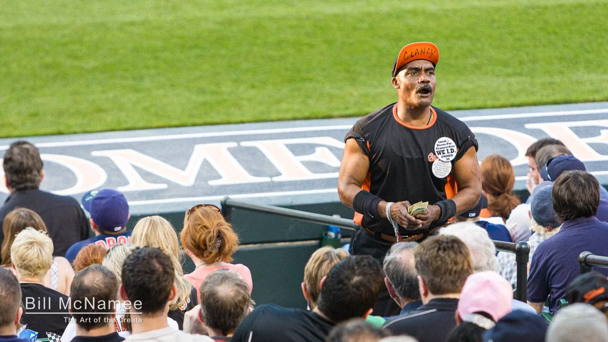 Beer vendor named Clancy working the stands at Camden Yards during an Orioles game.