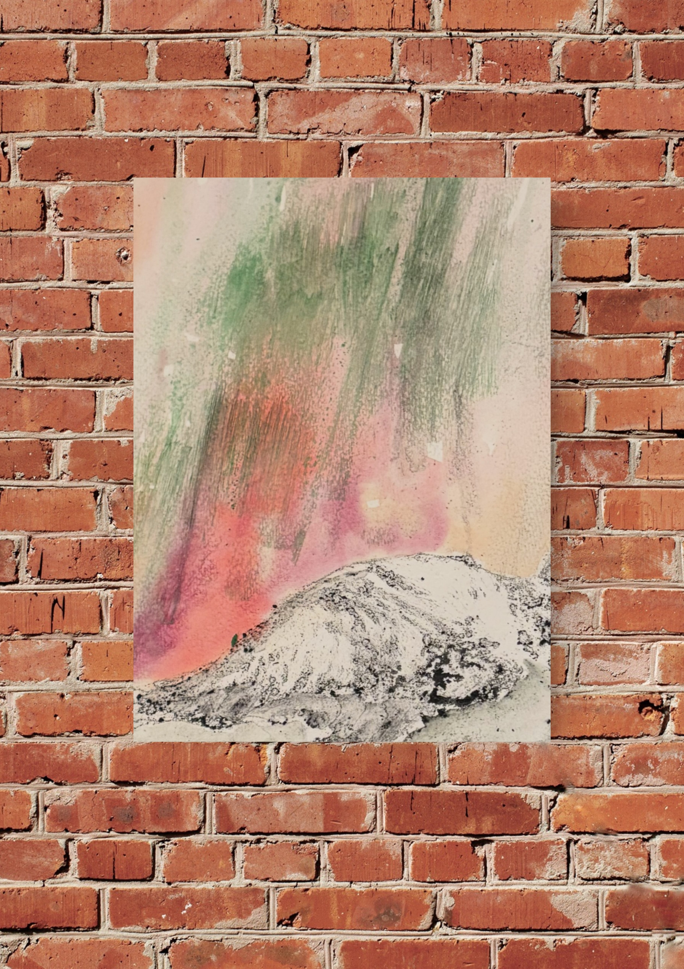 An abstract painting with streaks of green, pink, and gray on a paper or canvas, mounted on a brick wall.