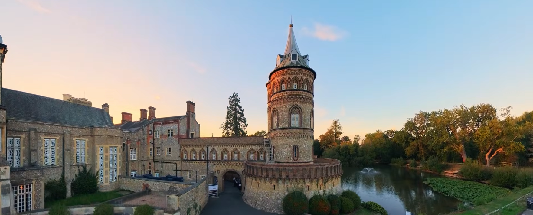 De Vere Horsley Estate carousel cover showing Horsley Towers beside the lake in warm evening light,