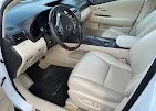 The interior of a car with beige leather seats, steering wheel, and dashboard visible.