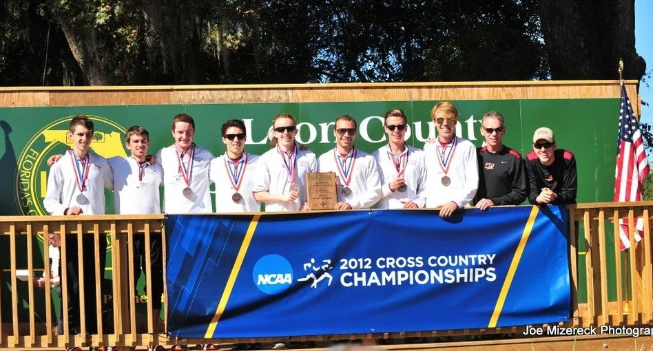 Florida State men's cross country team on the podium at the 2012 NCAA Division I Regional Championships, holding a trophy and wearing medals.