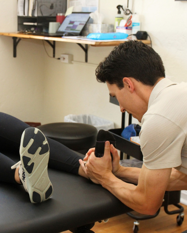 Sports Chiropractor treating a patient’s foot and ankle during a sports injury session at CB Movement Co. in Crested Butte, Colorado.