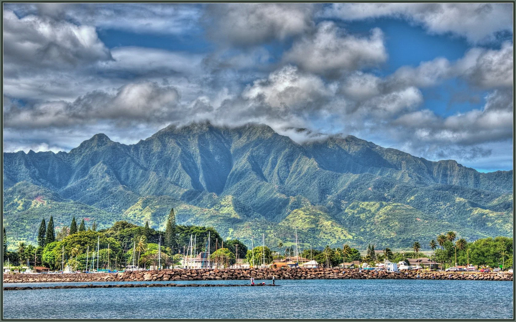 People fishing on a jetty at Haleiwa Harbor (Hawaii):