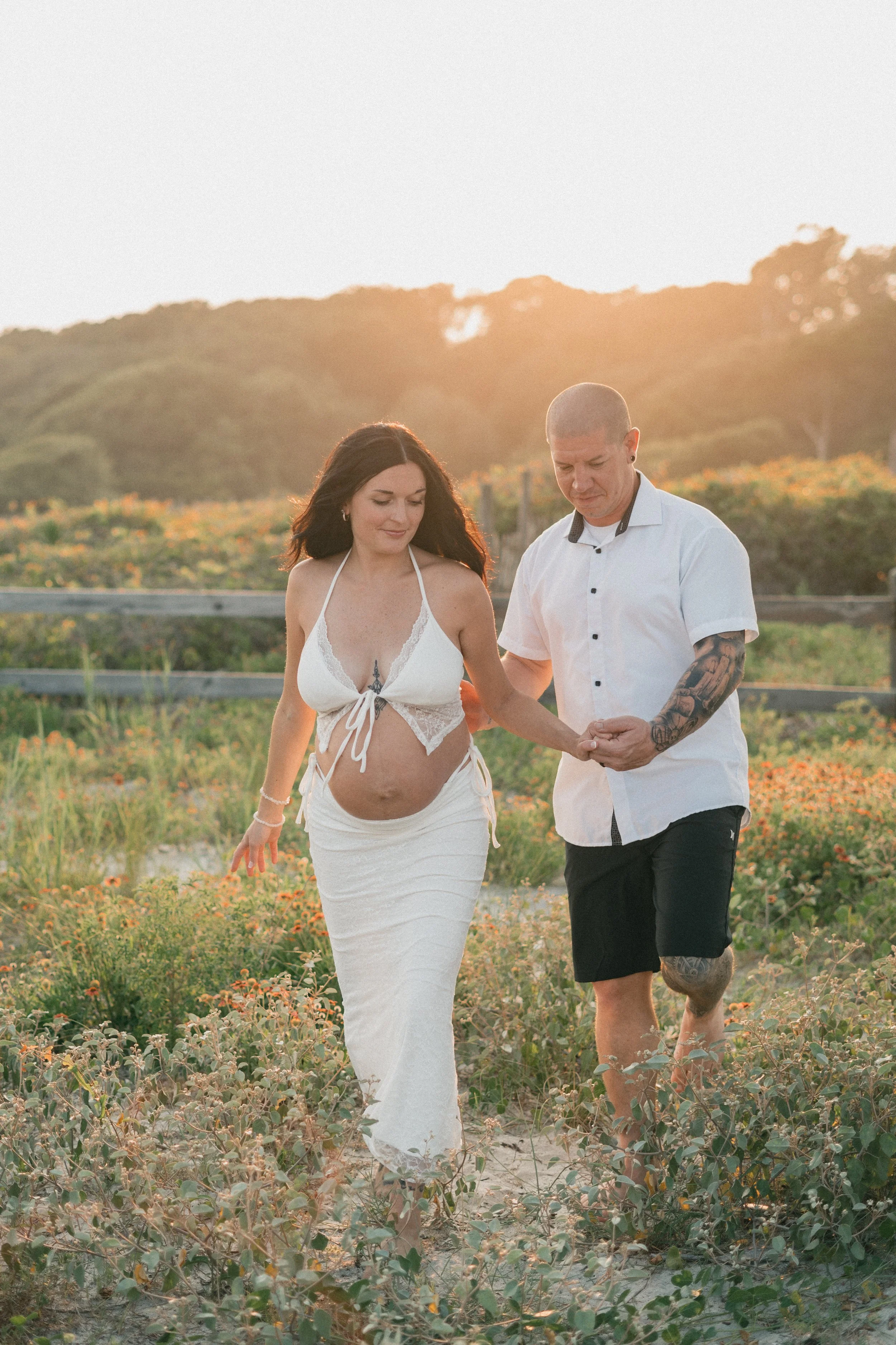 myrtle-beach-state-park-maternity-couple-walking-carly thompson photography.jpg