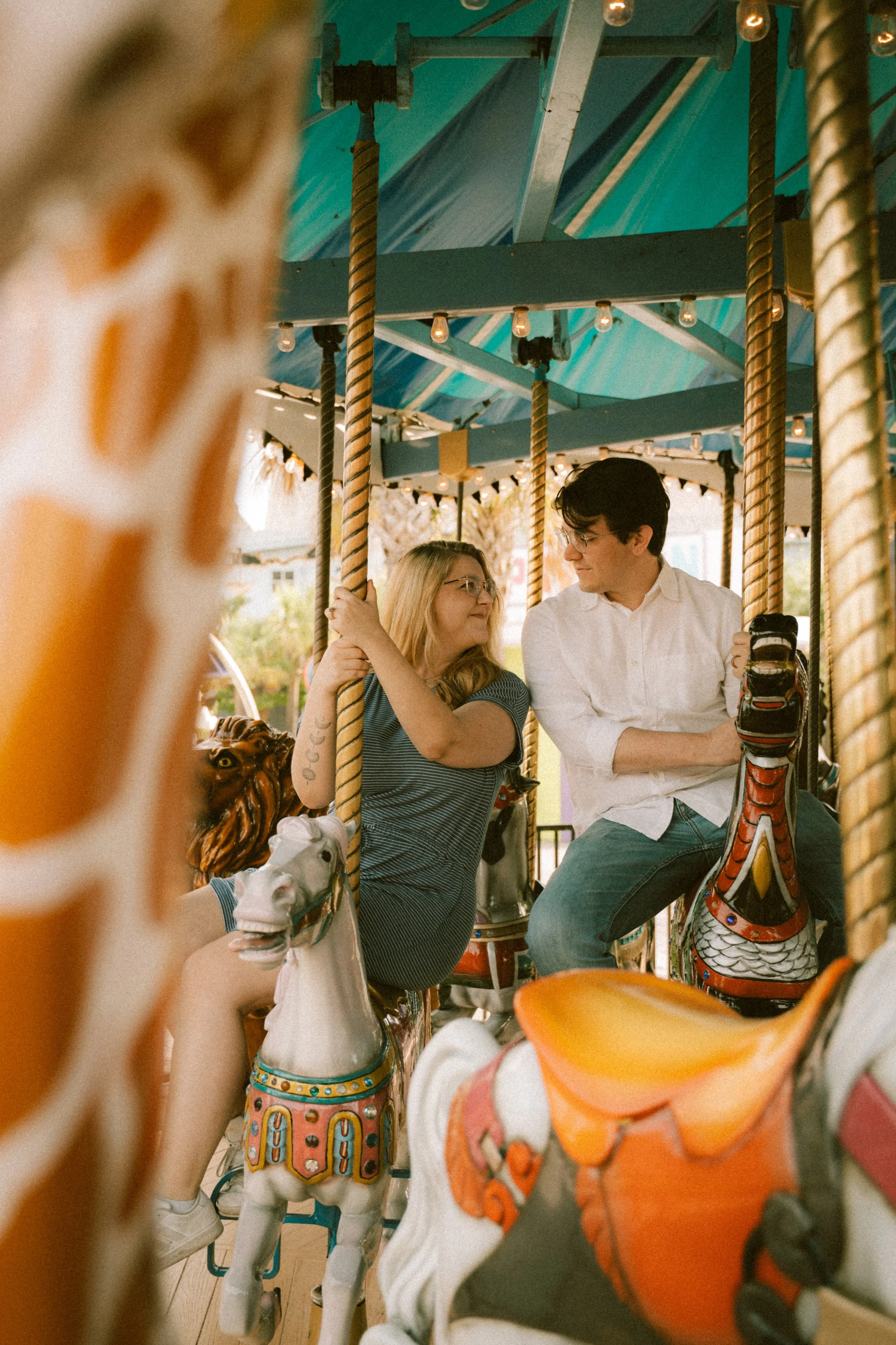 broadway-at-the-beach-myrtle-carousel-couple-engagement-film-carly thompson photography.jpg