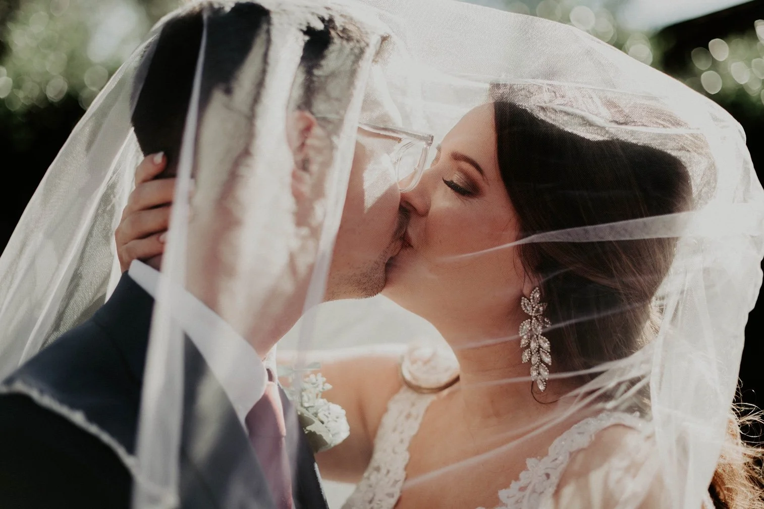thompson-farm-wedding-couple-kissing-under-veil-carly thompson photography.jpg
