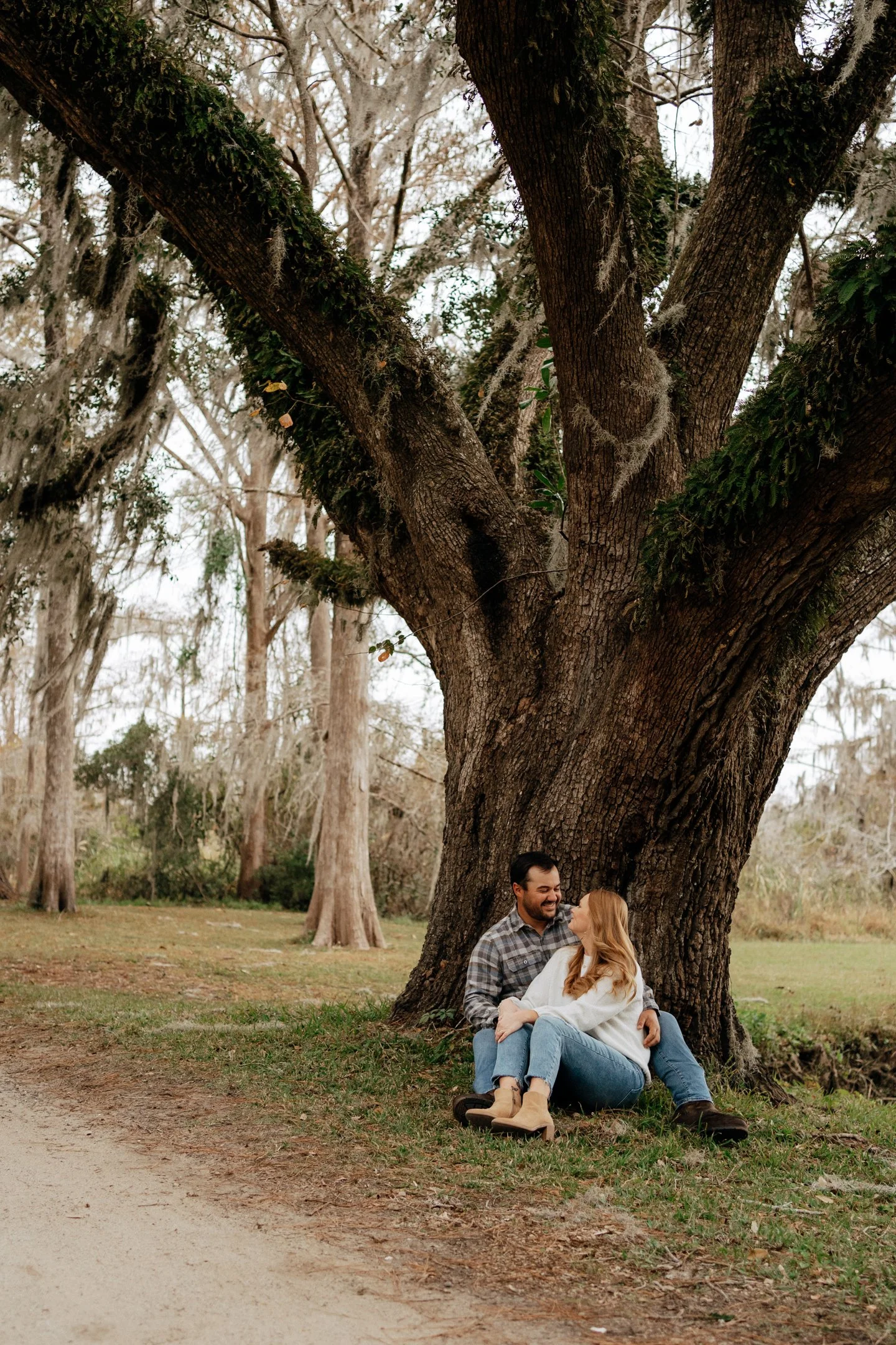 brookgreen-gardens-engagement-couple-sitting-oak-tree-carly thompson photography.jpg.jpg