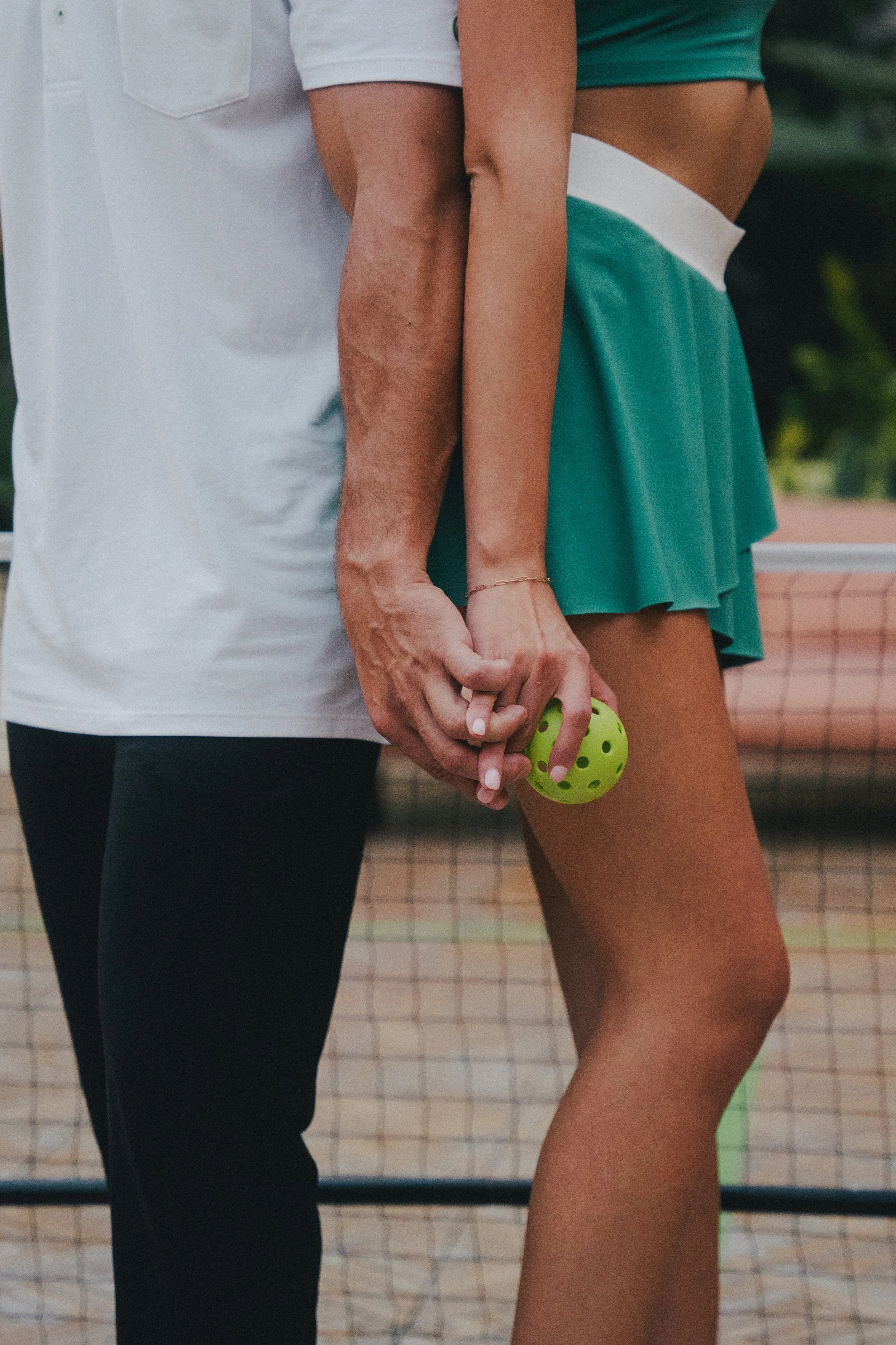 charleston-ryder-hotel-pickleball-engagment-couple-holding-hands-carly thompson photography.jpg
