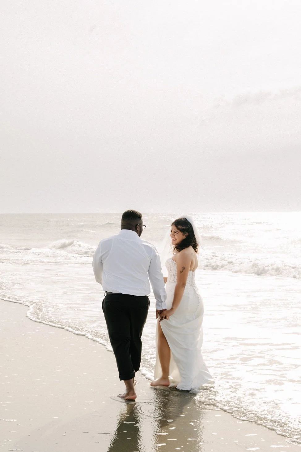 huntington-beach-state-park-myrtle-beach-elopement-walking-on-beach-carly thompson photography.jpg