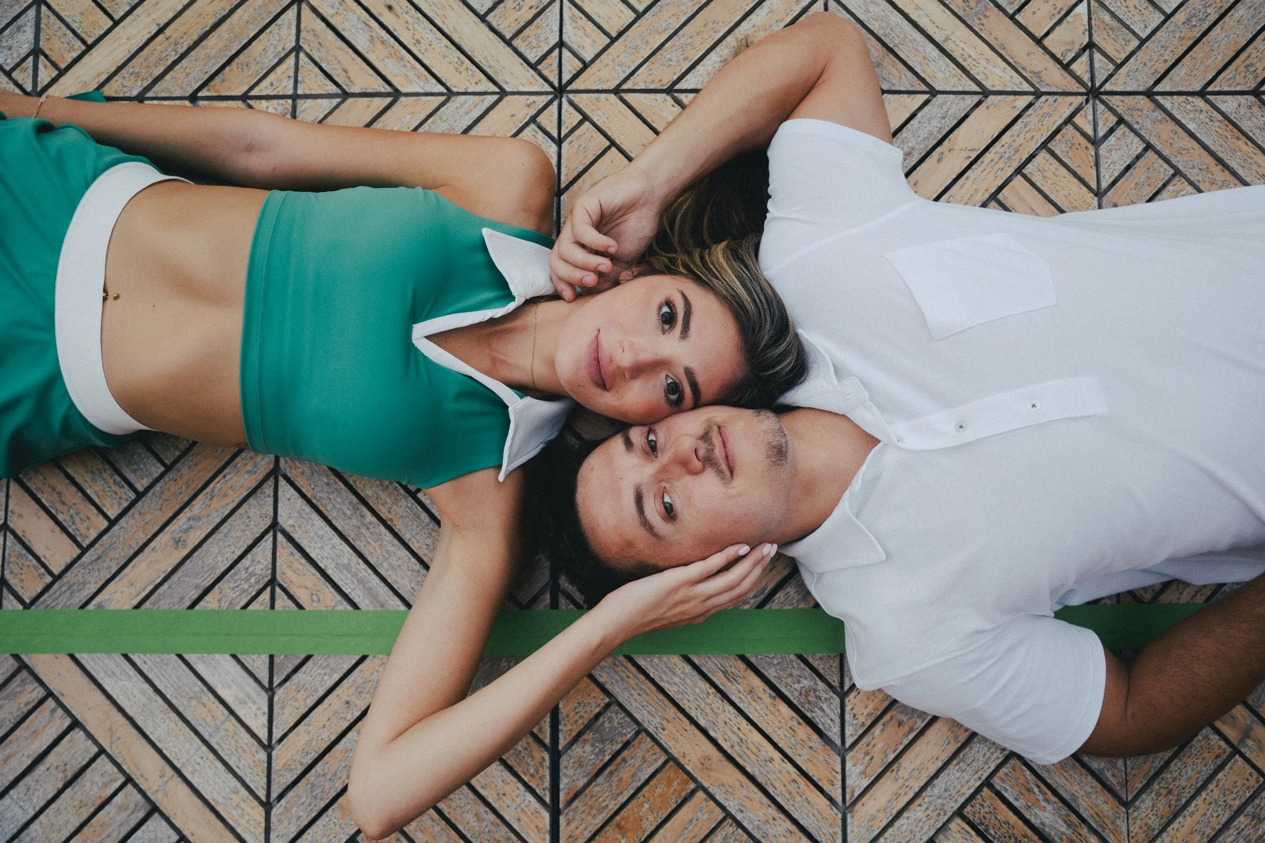 charleston-ryder-hotel-pickleball-engagment-couple-laying-on-court-carly thompson photography.jpg