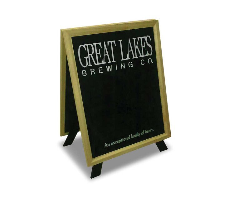 A black chalkboard sign with a wooden frame promoting Great Lakes Brewing Co., stating it's "An exceptional family of beers".
