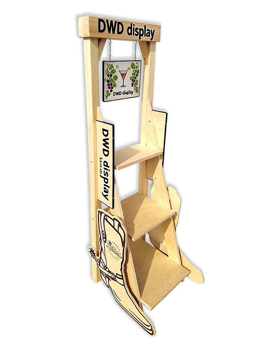 Wooden display stand with multiple shelves and signs related to wine, featuring a small sign with grapevine and wine glass illustration and a large wine glass cutout at the bottom.
