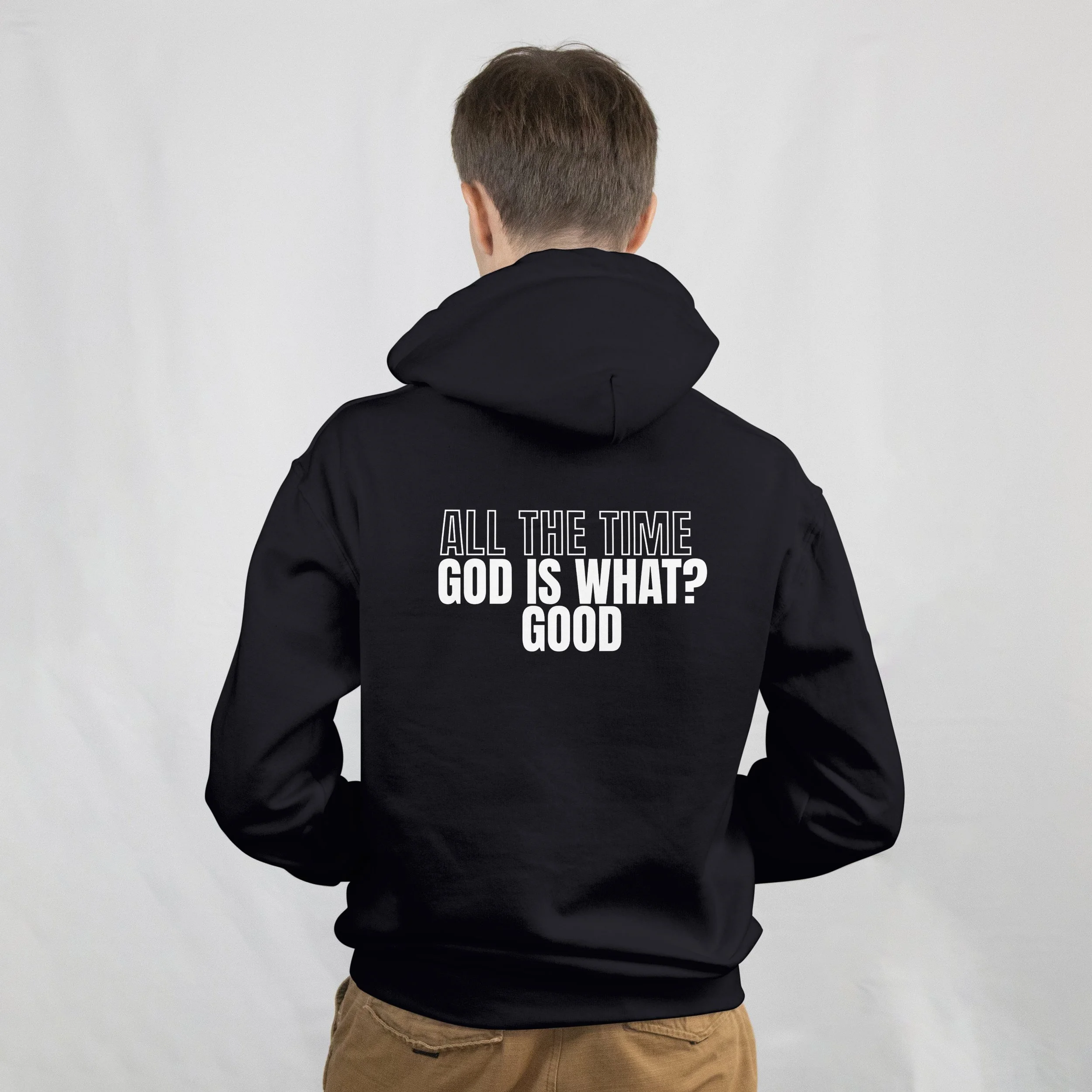 Back view of a person wearing a black hoodie with white text on the back that reads, "ALL THE TIME GOD IS WHAT? GOOD."
