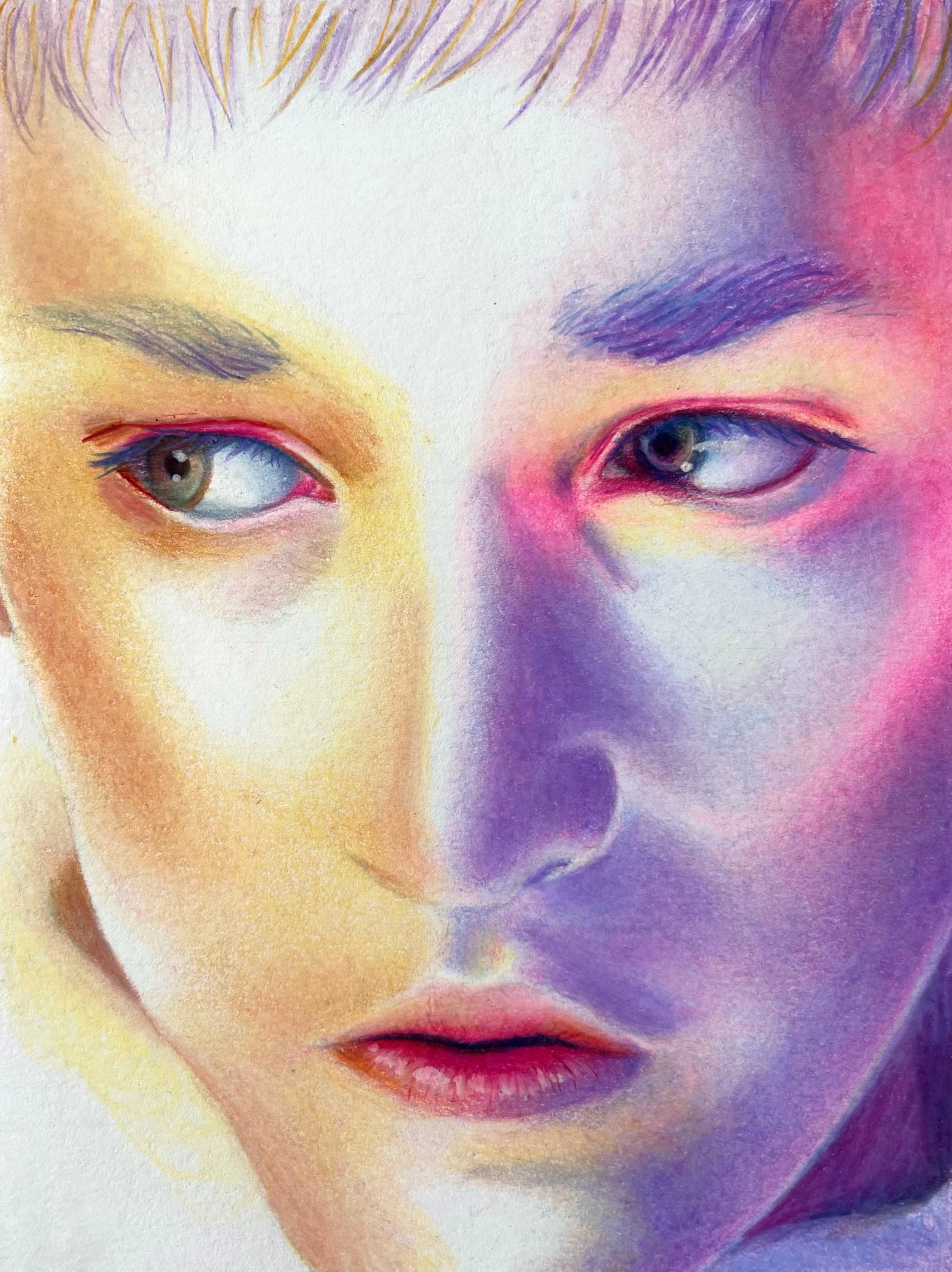 Close-up of a pastel drawing of two women's faces, showing their eyes, noses, and lips, with one face shaded in warm tones and the other in cool tones.