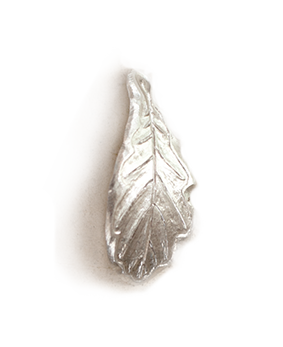 Silver leaf-shaped object, possibly a decorative pin or charm