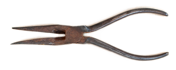 Close-up of a metal prong tool with two curved tines and a handle.