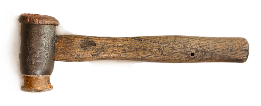 An old hammer with a rusty metal head and a weathered wooden handle.