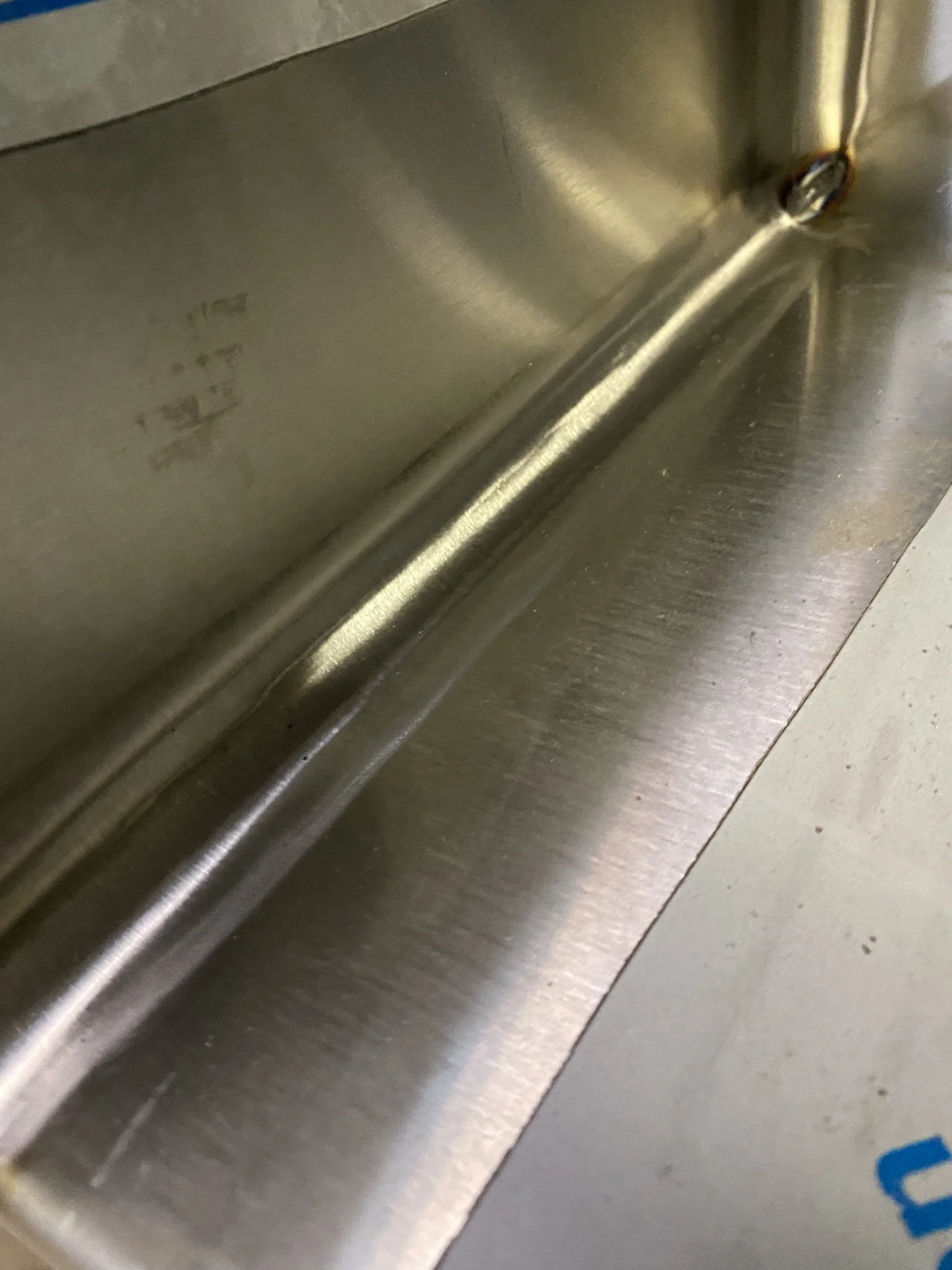 polishing process of refinishing the grain on stainless steel inside corner of sink