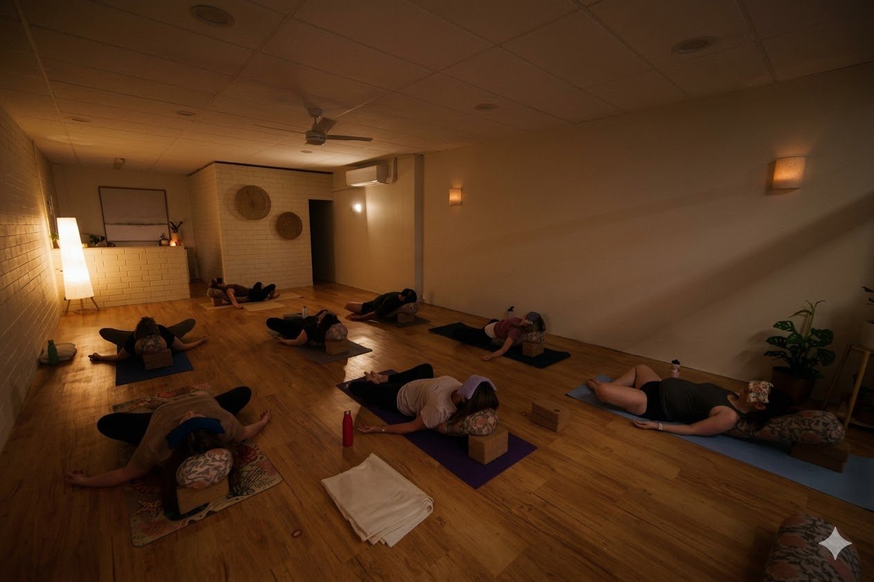Students lying down resting in a yoga class