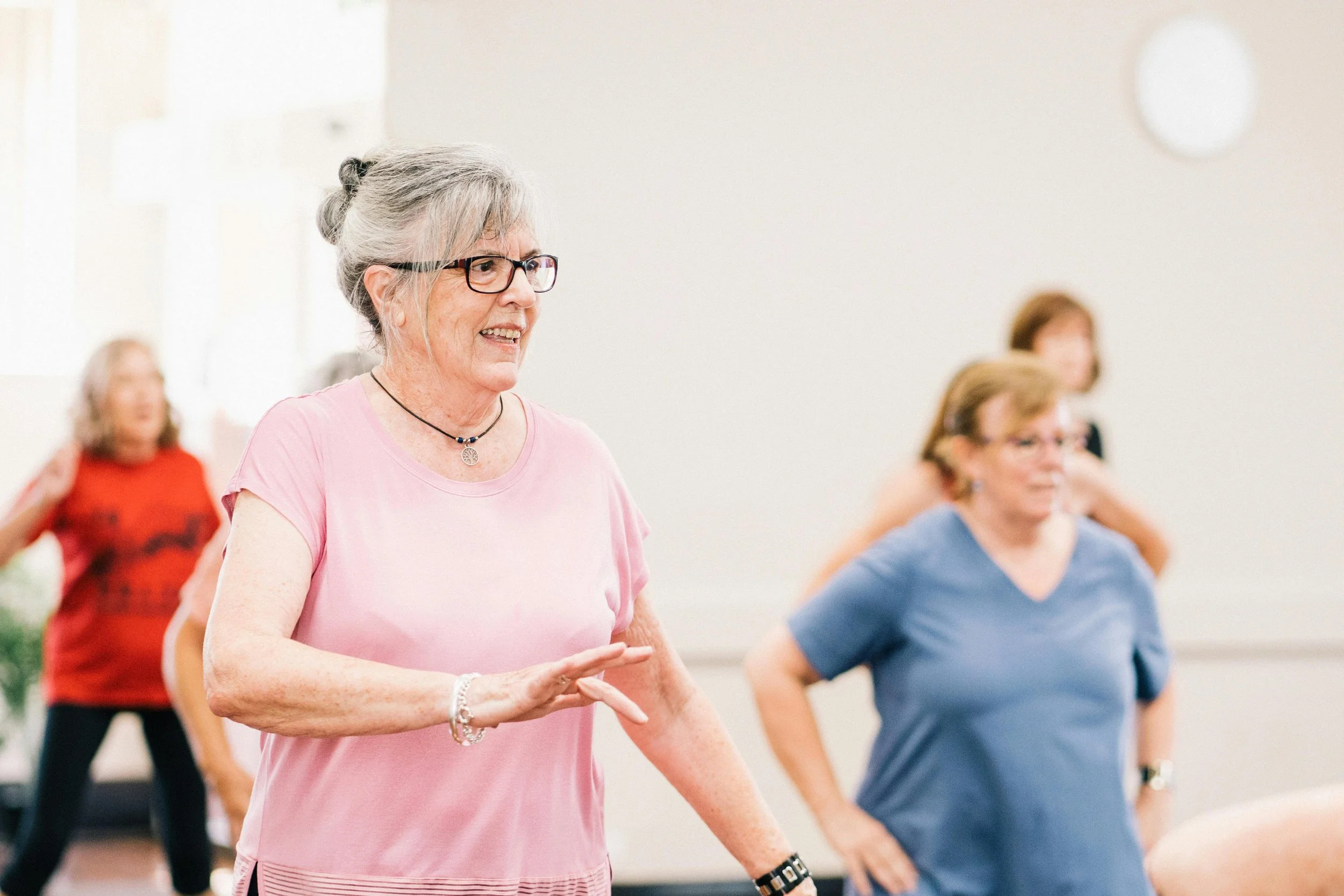 Senior lady doing yoga with pink t shirt