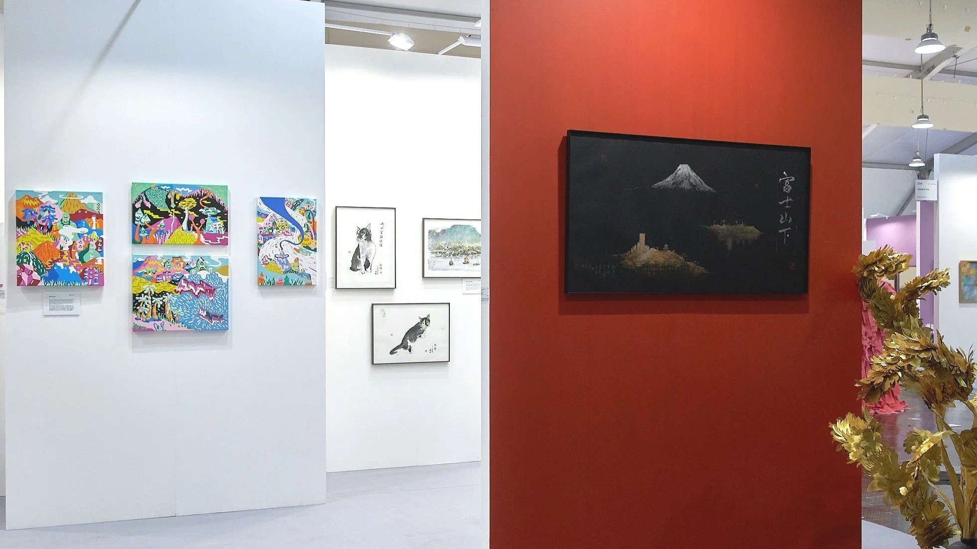 Art Central 2025: Gallery with colorful paintings of landscapes and animals on white wall on the left, and a Japanese-style painting of Mount Fuji on a red wall on the right.
