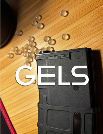 A gun magazine with several rounds of ammunition "Gels" on top of it, on a wooden surface.