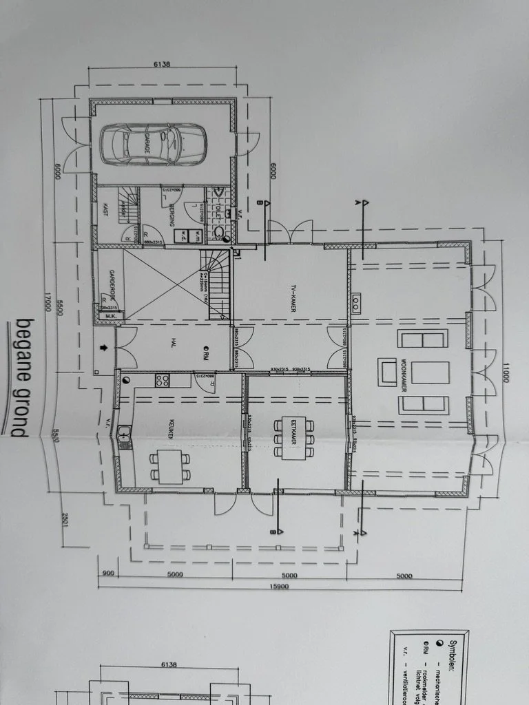 Architectural floor plan of a house, showing rooms including a garage, kitchen, living room, and stairs, with labeled dimensions and entry points.