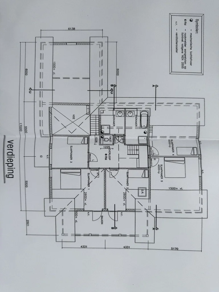 Architectural floor plan of a residential building with labeled rooms, measurements, and a legend on the top right corner.