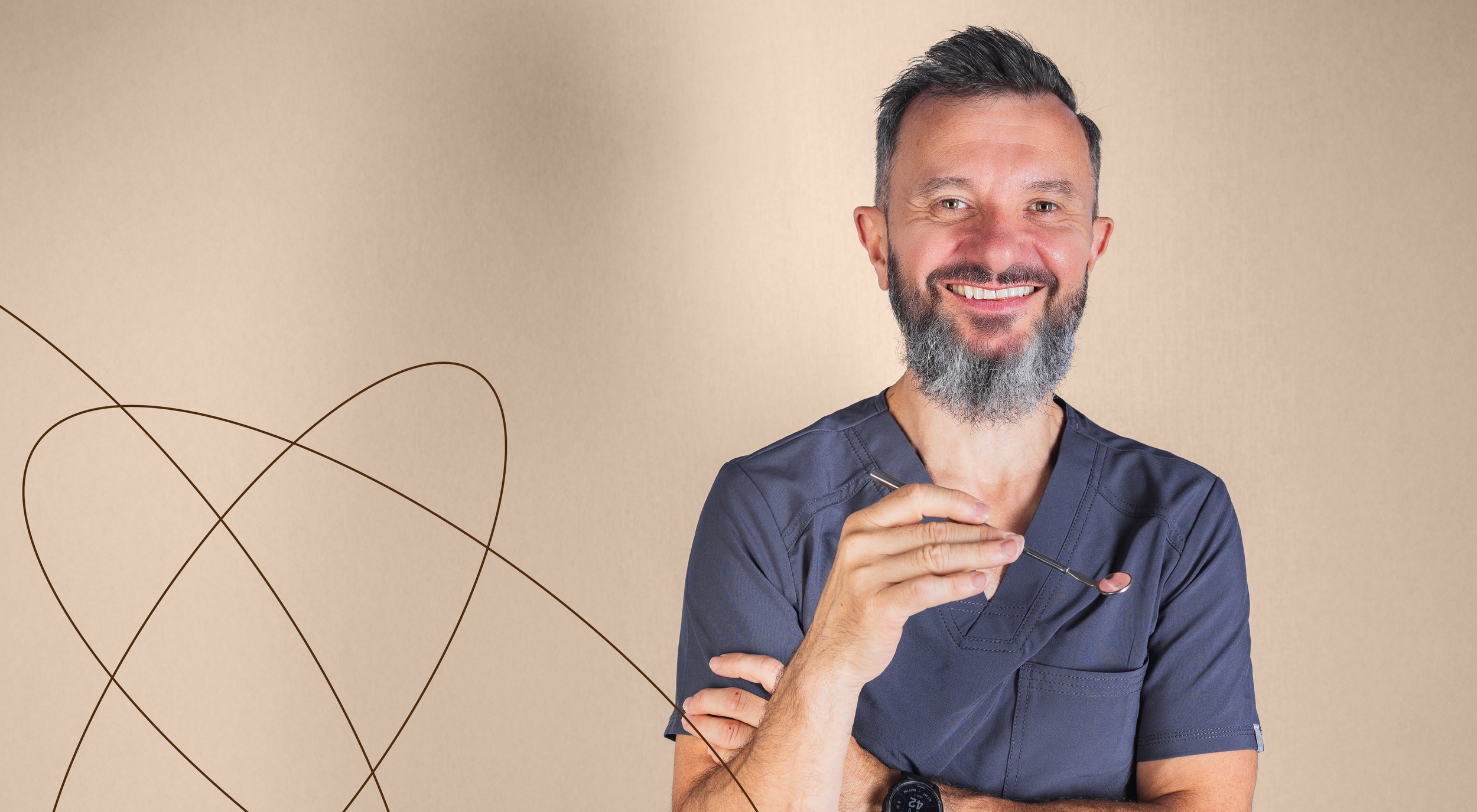 A smiling man with a beard and short dark hair, wearing medical scrubs, holding a dental mirror, standing against a beige background with decorative line art.