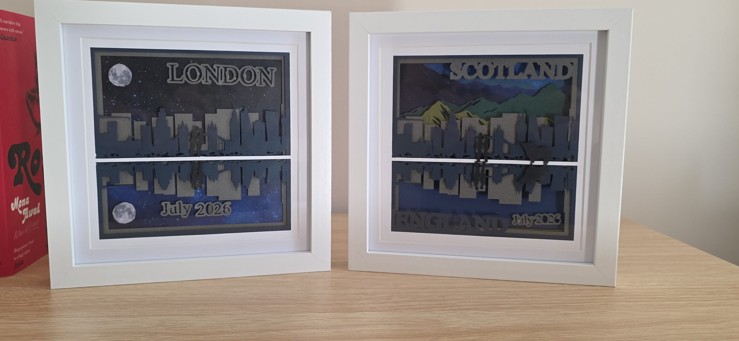 2 Paper cut layered pictures. Left is a skyline of London and the reflection of the same skyline. Word London in top right and July 2026 bottom centre. Right picture is skyline of London and mountains of Scotland in the background. 